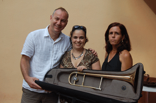 Staff from CNEArt receive a trombone donated to the Music Fund