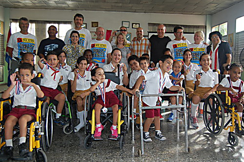 Students showing off their medals with School director Esther María La Ochoa, Gerardo Hernández, and cyclists on the 2015 Cuba Cycle Challenge 