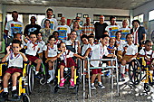 Students showing off their medals with School director Esther María La Ochoa, Gerardo Hernández, and cyclists on the 2015 Cuba Cycle Challenge 