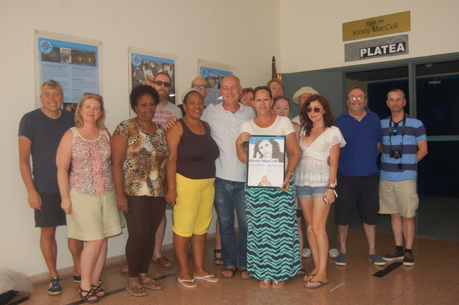 Miramar Theatre staff are presented with a new display plaque on Kirsty MacColl by participants on the 2017 Cycle Cuba Challenge