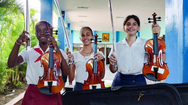 First year students at the Alejandro García Caturla Elementary School of Music receive new violins