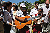 Handing over a guitar to one of the students